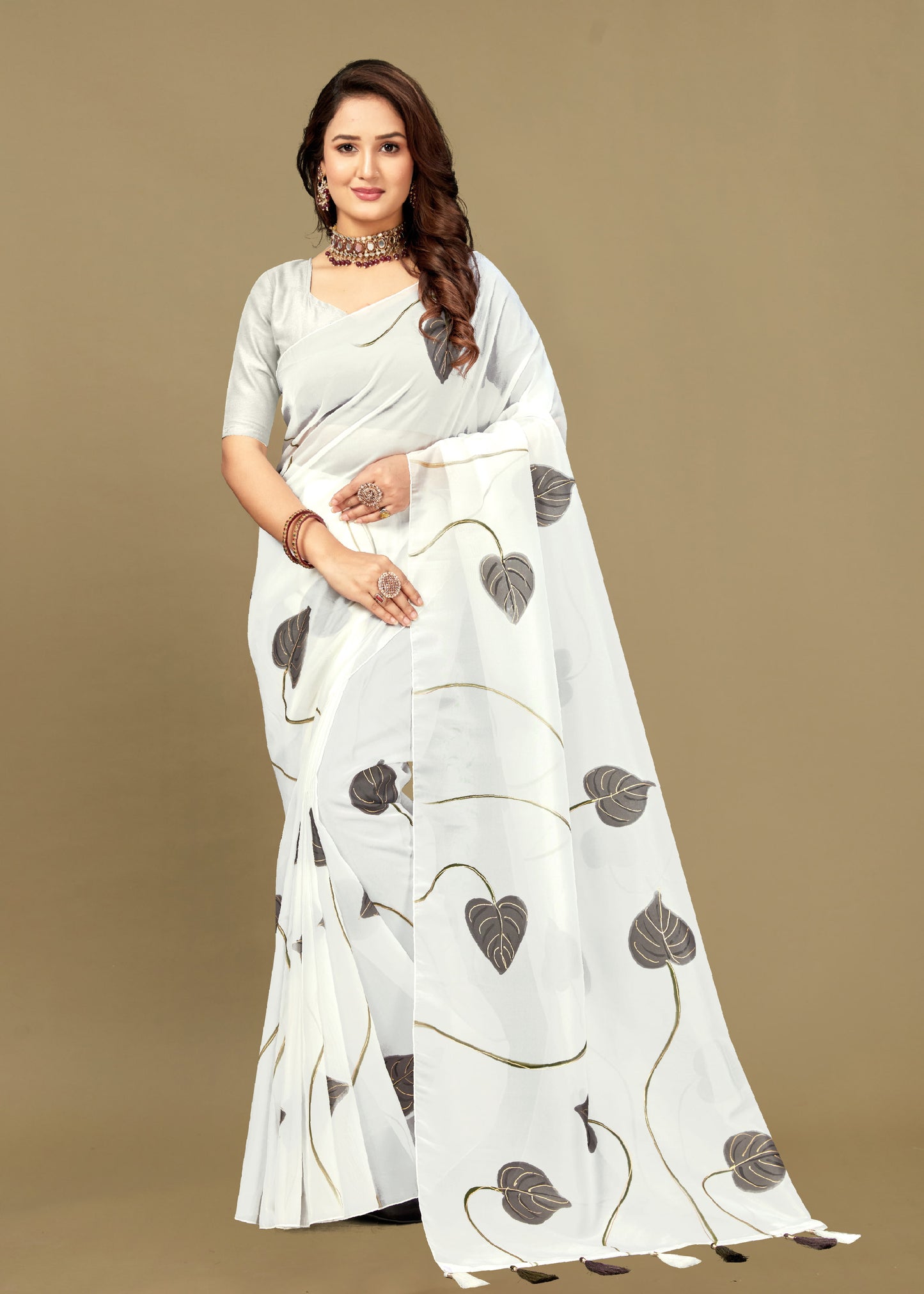 Elegant Off-White Organza Saree with Hand-Painted Leaf Motifs, Delicate Foil Work, and Tassel Accents