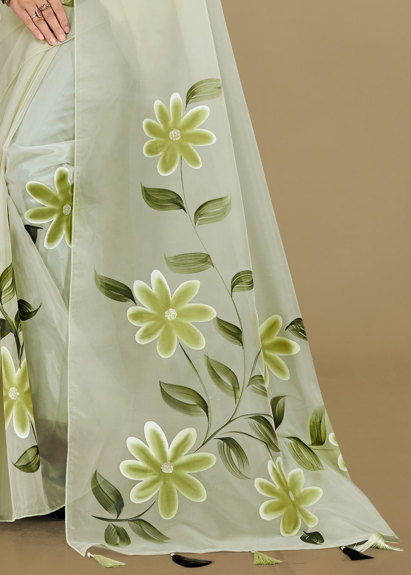 Floral-patterned fabric with green flowers and leaves on a beige background